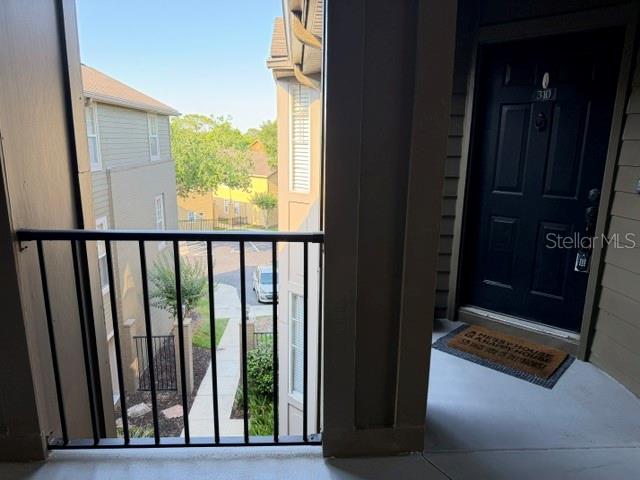 A view from a balcony looking out toward a neighboring building and a parking area — 420 SUMMIT RIDGE PLACE UNIT 310, LONGWOOD, FL