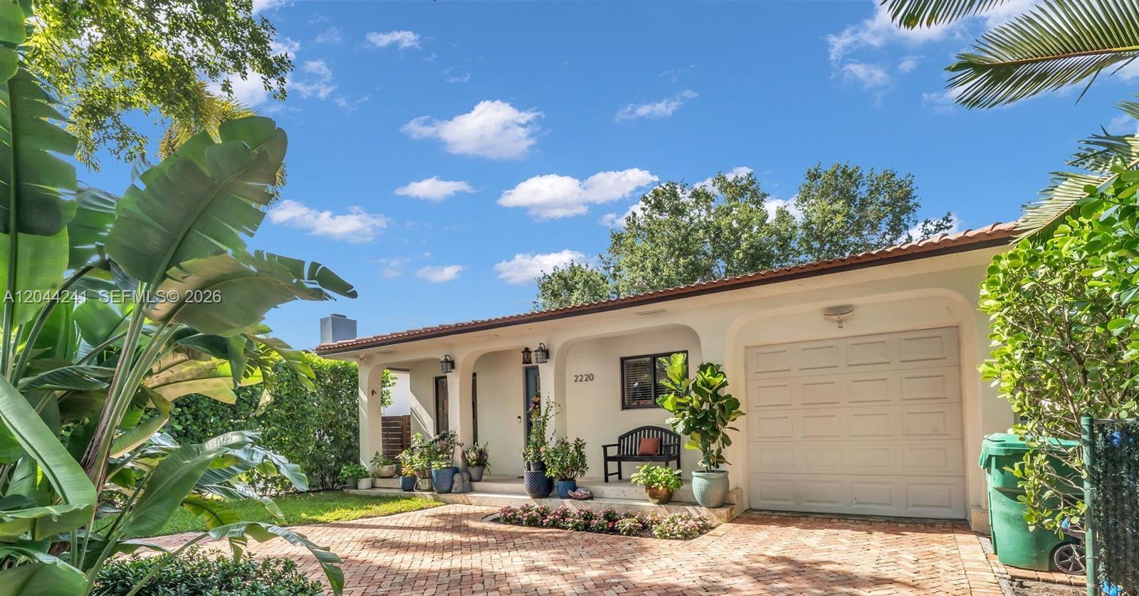 A single-story house with a brick driveway, arched entryway, and a one-car garage — 2220 SW 25th St, Miami FL 33133, MIAMI, FL