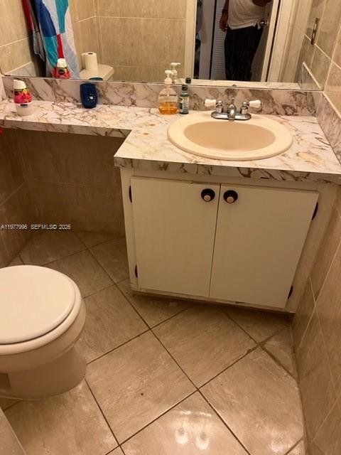 A bathroom features a marble-patterned vanity countertop, a white cabinet, and a toilet — 2029 NW 46th Ave # E503, Lauderhill FL 33313, LAUDERHILL, FL