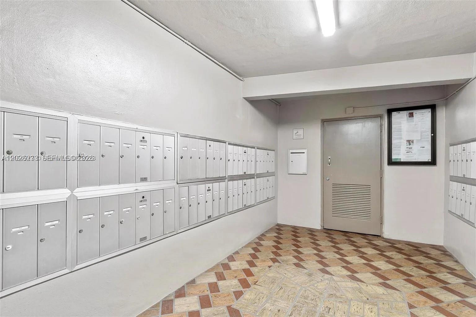 A mailroom features rows of metal mailboxes, a beige door, and a patterned tile floor — 8420 SW 133rd Ave Rd # 307, Miami FL 33183, MIAMI, FL