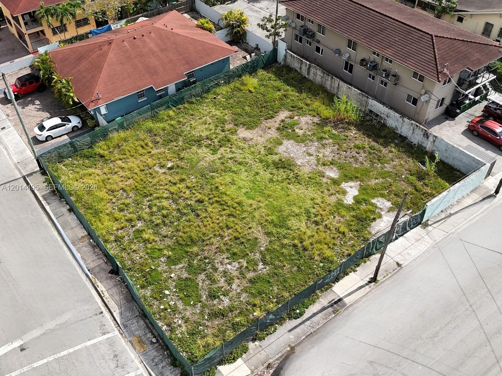 An aerial view shows a fenced, vacant rectangular lot situated between two residential buildings — 2141 SW 3rd St, Miami FL 33135, MIAMI, FL