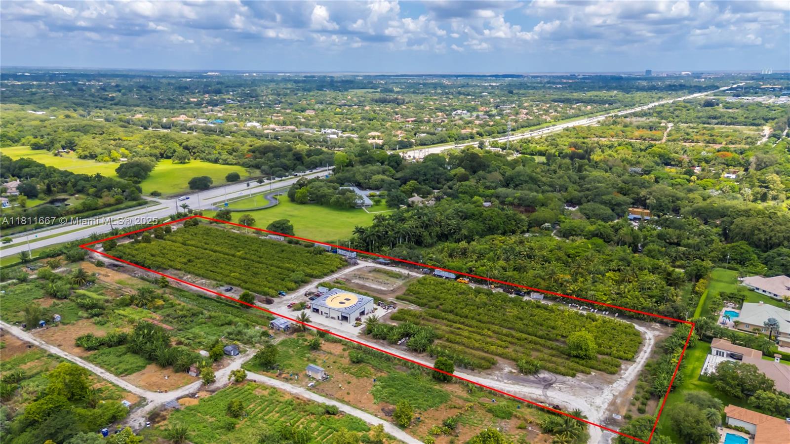 An aerial view shows a rectangular lot with a building featuring a smiley face roof — 4077 SW 121st Ter, Davie FL 33330, DAVIE, FL