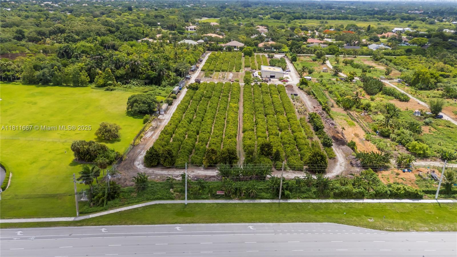 An aerial view shows a large agricultural plot with rows of trees and a warehouse — 4077 SW 121st Ter, Davie FL 33330, DAVIE, FL