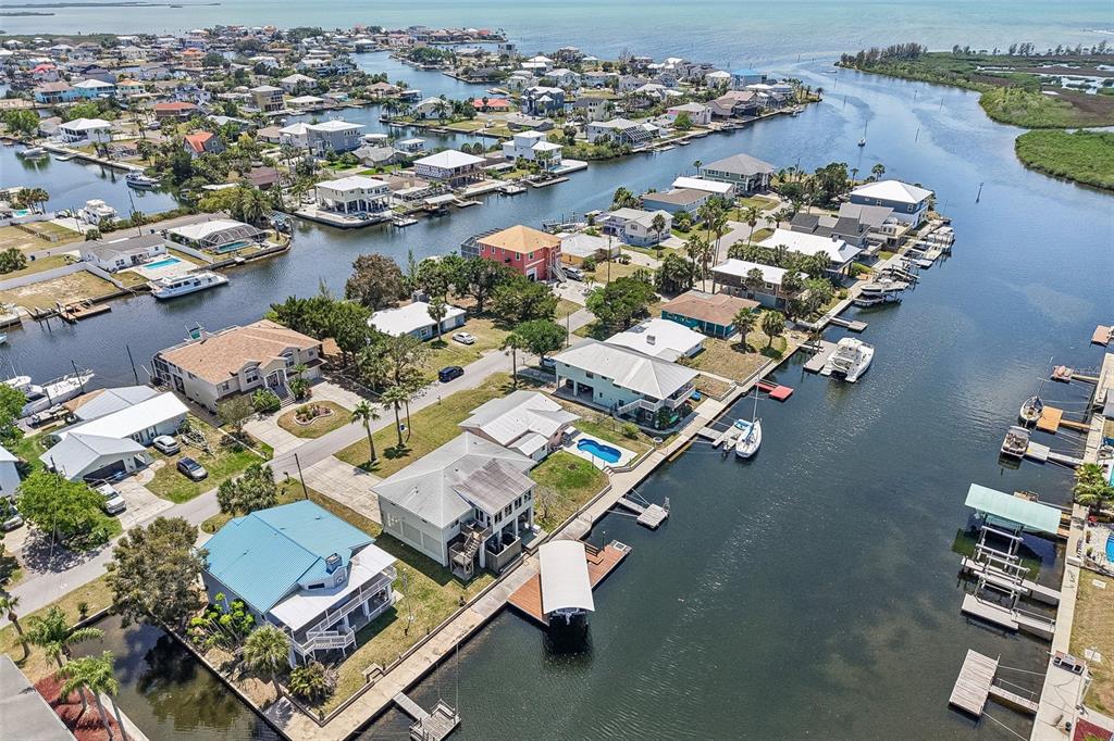 An aerial view shows waterfront houses with private docks along a canal in a neighborhood — 3303 MINNOW CREEK DRIVE, HERNANDO BEACH, FL