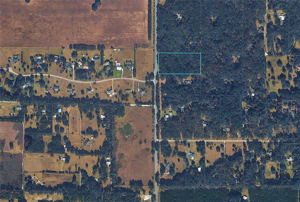An aerial view shows a rectangular plot of land highlighted in blue along a road — NW 143RD STREET, GAINESVILLE, FL