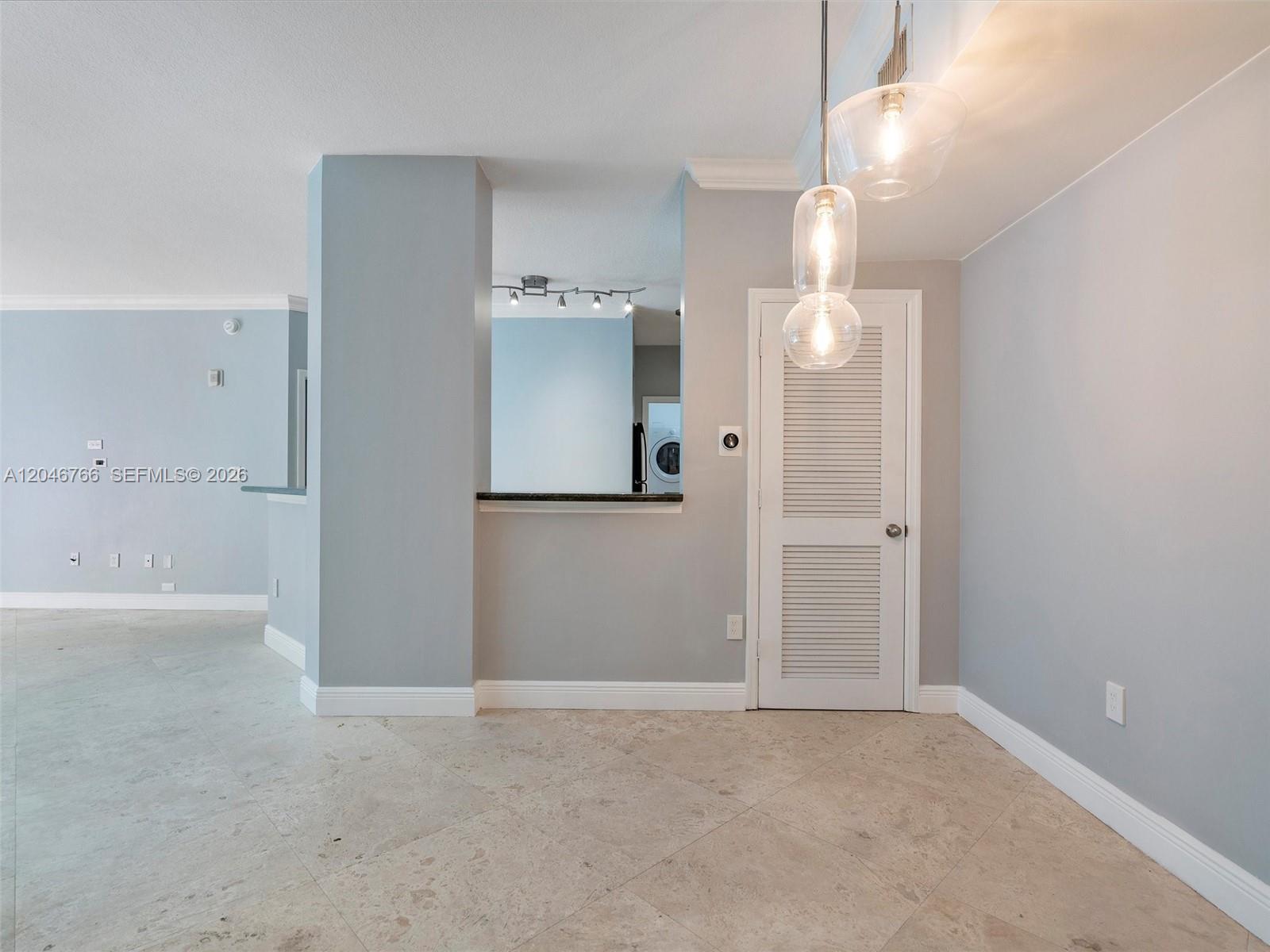 This room features light gray walls, tile flooring, a louvered door, and hanging pendant lights — 9172 Collins Ave # 216, Surfside FL 33154, SURFSIDE, FL