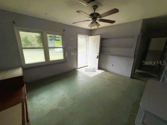 An interior room features a ceiling fan, light-colored walls, a door, and a built-in shelf — 6292 W PARK DRIVE, HOMOSASSA, FL