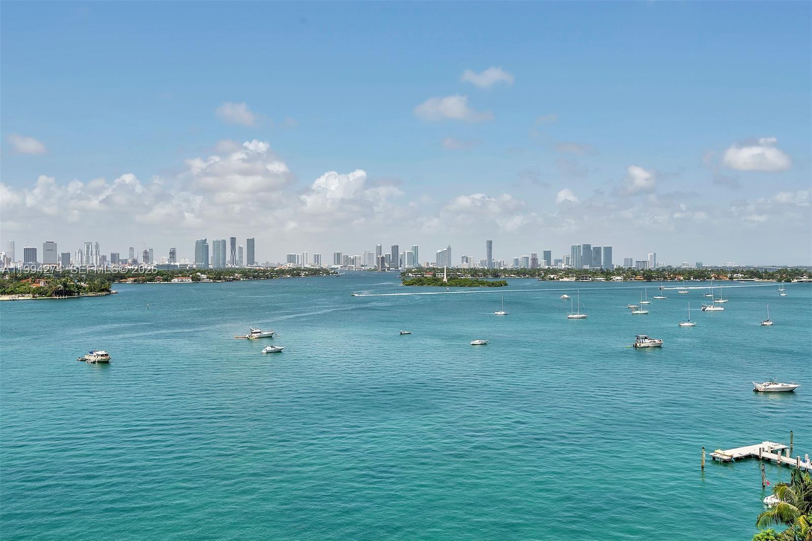 A wide-angle view of a bay with numerous boats and a distant city skyline — 1100 West Ave # 1020, Miami Beach FL 33139, MIAMI BEACH, FL