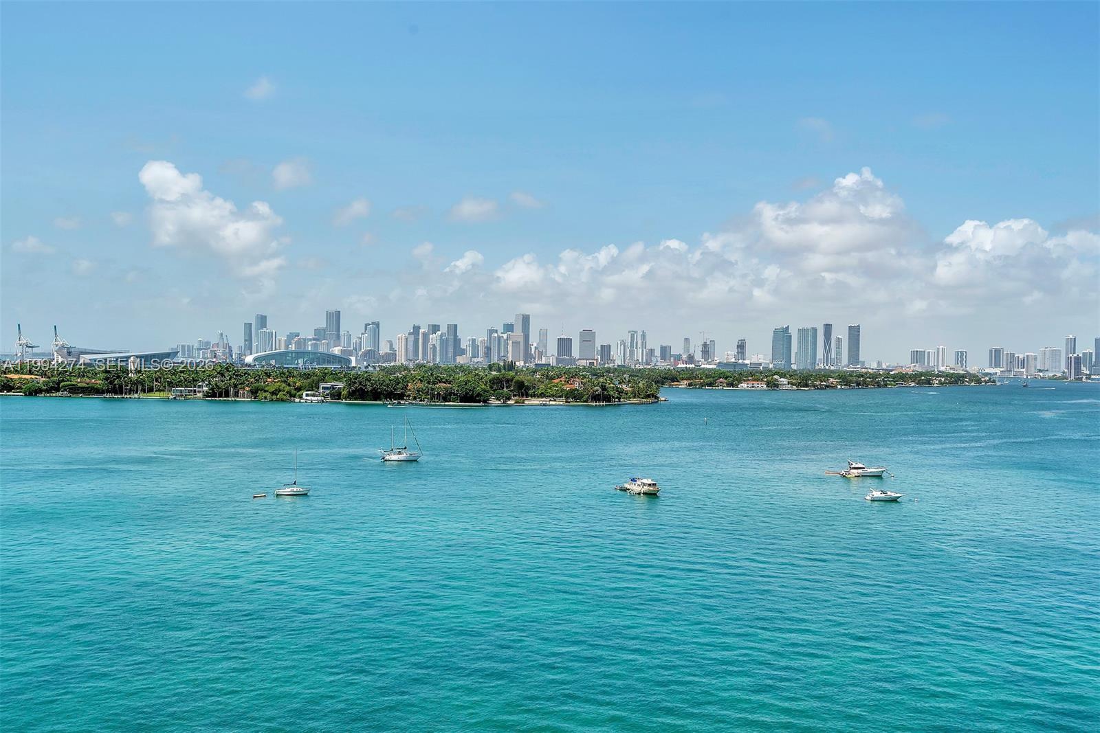 A wide-angle view of the Miami skyline across a bay with several boats — 1100 West Ave # 1020, Miami Beach FL 33139, MIAMI BEACH, FL