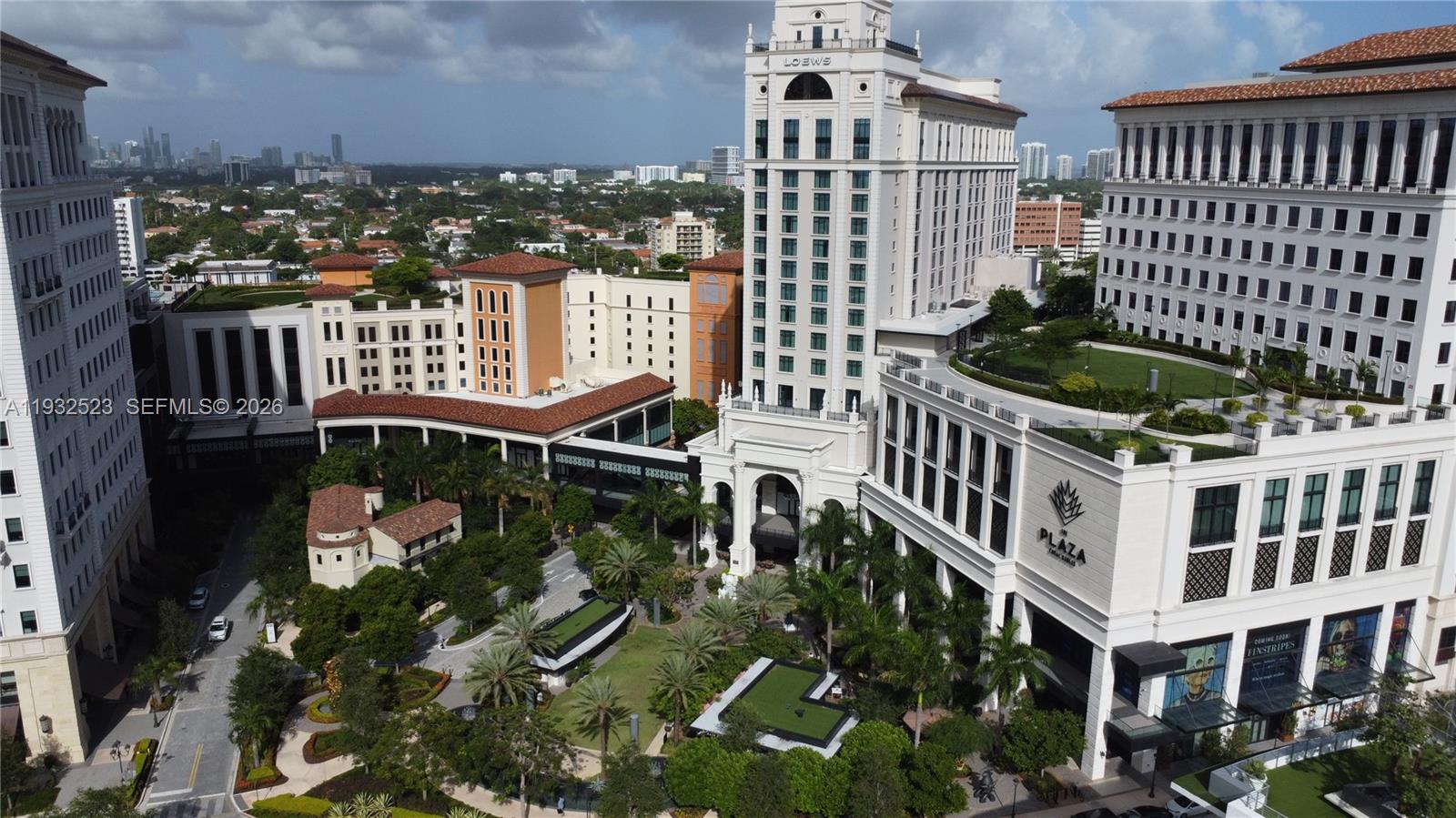 An aerial view of a large hotel and plaza complex with landscaped courtyards and walkways — 3011 Ponce de Leon Blvd, Coral Gables FL 33134, CORAL GABLES, FL