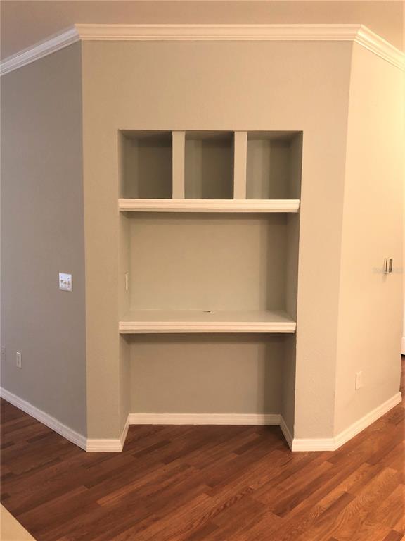A built-in desk and shelving unit are recessed into a wall with light-colored paint — 3725 CONROY ROAD UNIT 2113, ORLANDO, FL