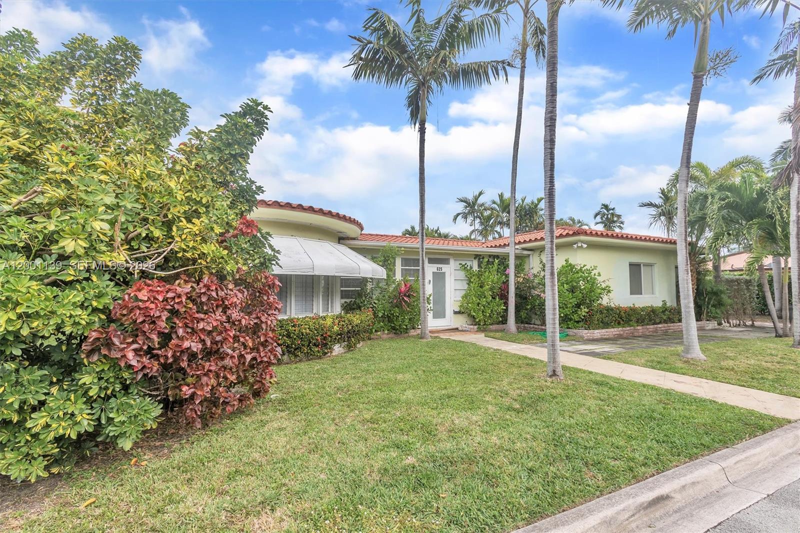A single-story house with a curved roof section, palm trees, and a front lawn — 625 93rd St, Surfside FL 33154, SURFSIDE, FL