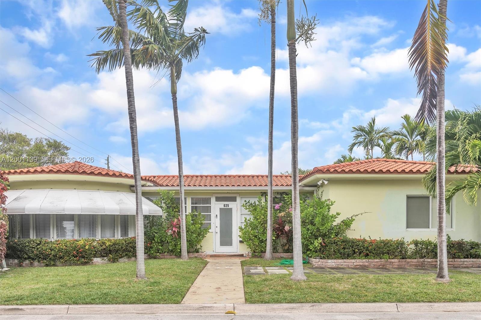 A single-story house with a tiled roof, palm trees, and a central front entrance — 625 93rd St, Surfside FL 33154, SURFSIDE, FL
