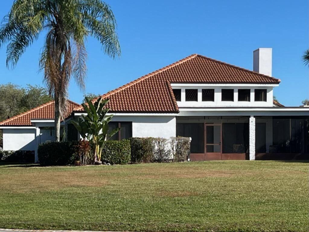 A white house with a terracotta tile roof and a large screened-in porch — 2990 Conifer Drive, Fort Pierce FL 34951, FORT PIERCE, FL