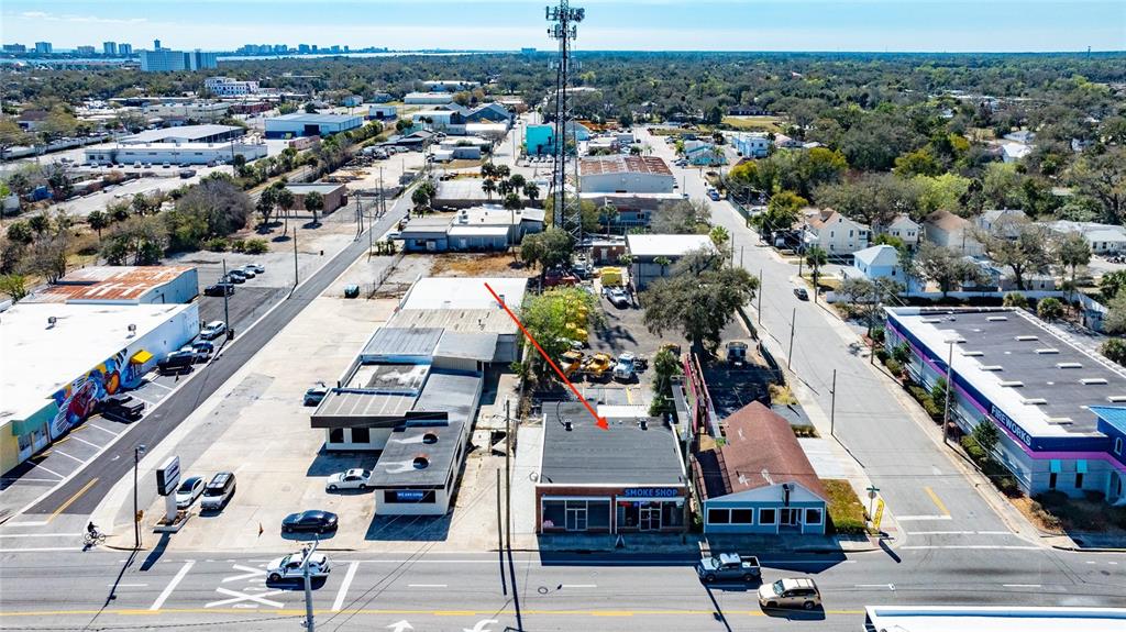 An aerial view shows a commercial street with a smoke shop and surrounding buildings — 517 W INTERNATIONAL SPEEDWAY BOULEVARD, DAYTONA BEACH, FL