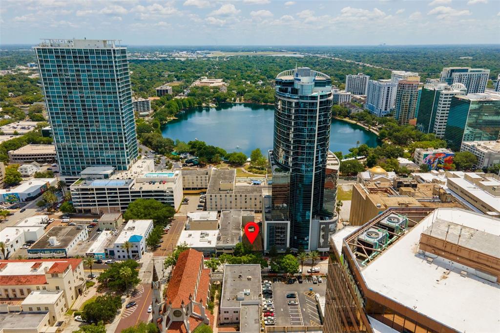 An aerial view of a downtown city area featuring high-rise buildings and a lake — 127 N MAGNOLIA AVENUE, ORLANDO, FL