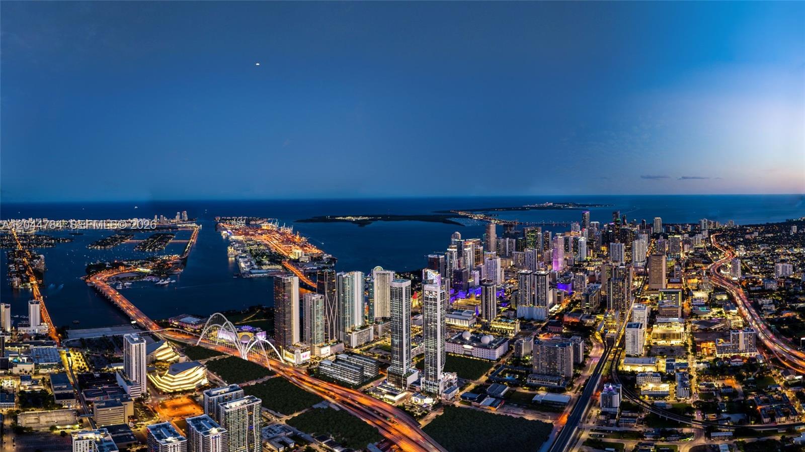 An aerial view of the Miami skyline at dusk featuring skyscrapers, bridges, and the harbor — 20 NE 11th # 2905, Miami FL 33132, MIAMI, FL
