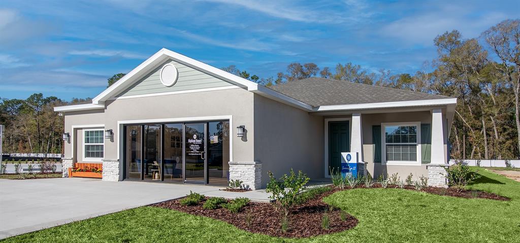 A single-story building with a concrete driveway, stone accents, and a front entrance — 10538 SW 76TH COURT, OCALA, FL