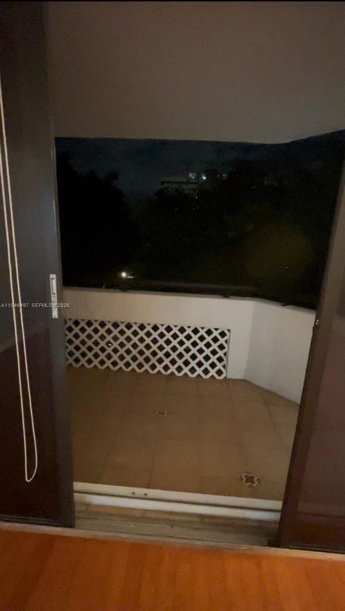 A kitchen features oak cabinets, granite countertops, stainless steel appliances, and a tiled backsplash — 911 E Ponce De Leon Blvd # 403, Coral Gables FL 33134, CORAL GABLES, FL