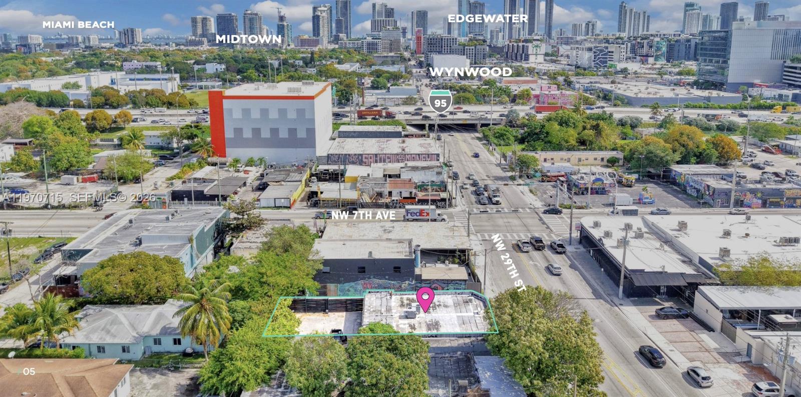 An aerial view shows a vacant lot and a flat-roofed building in an urban area — 719 NW 29th St, Miami FL 33127, MIAMI, FL