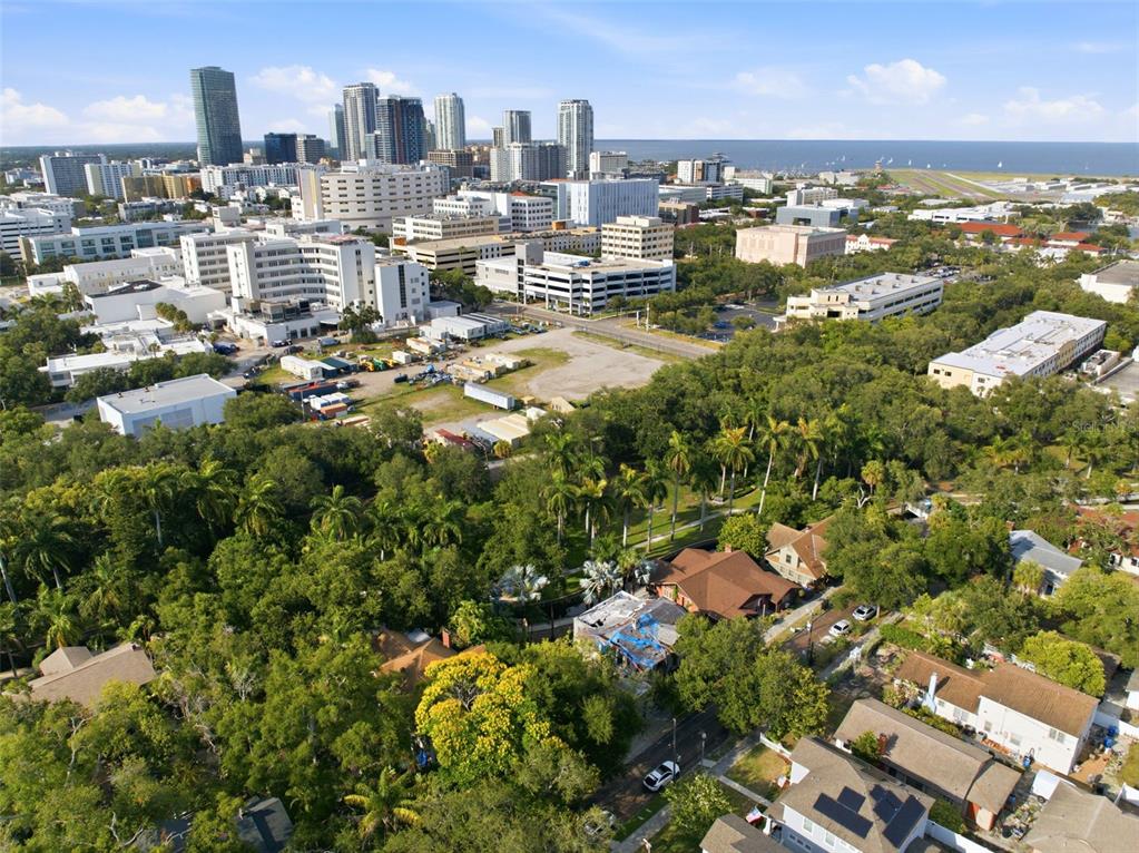 An aerial view shows a residential neighborhood in the foreground with a city skyline behind — 651 10TH AVE S, ST PETERSBURG, FL