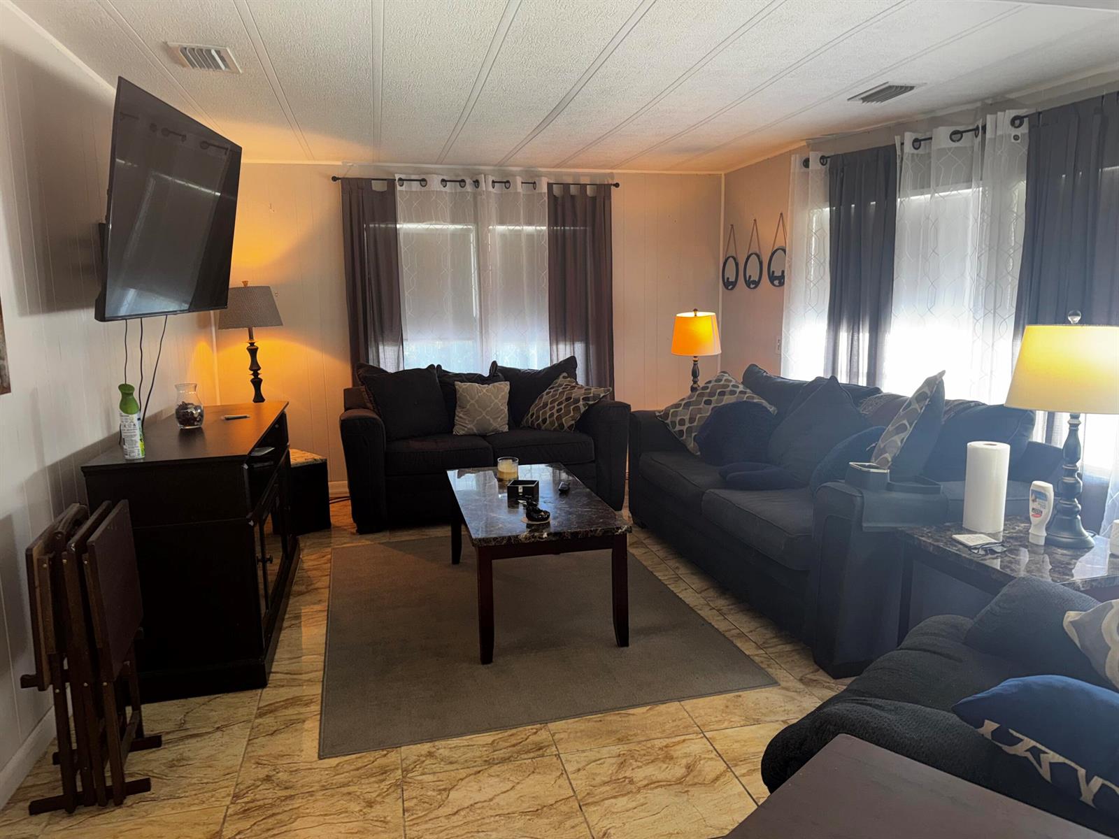 A living room features dark furniture, a marble-topped coffee table, and tiled flooring — 4242 3rd Court, Lantana FL 33462, LANTANA, FL