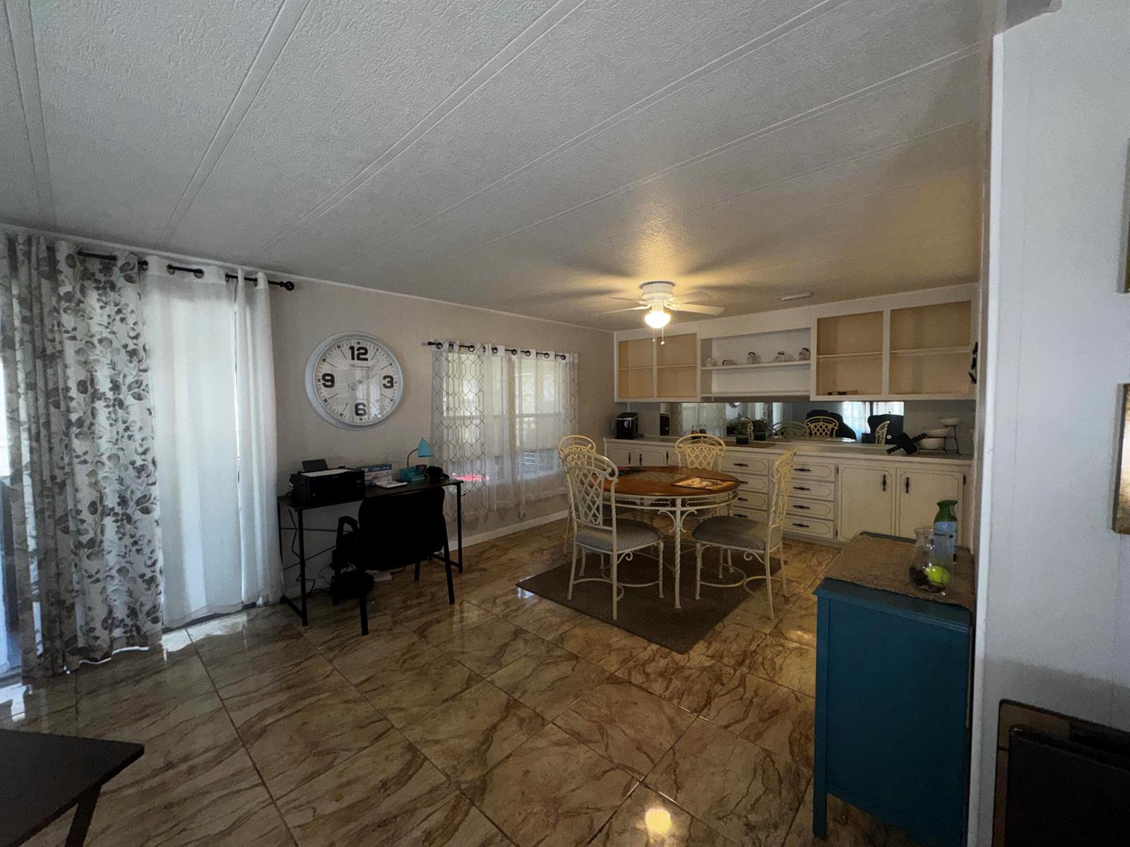 A dining area and office space with tile flooring, a ceiling fan, and white cabinetry — 4242 3rd Court, Lantana FL 33462, LANTANA, FL