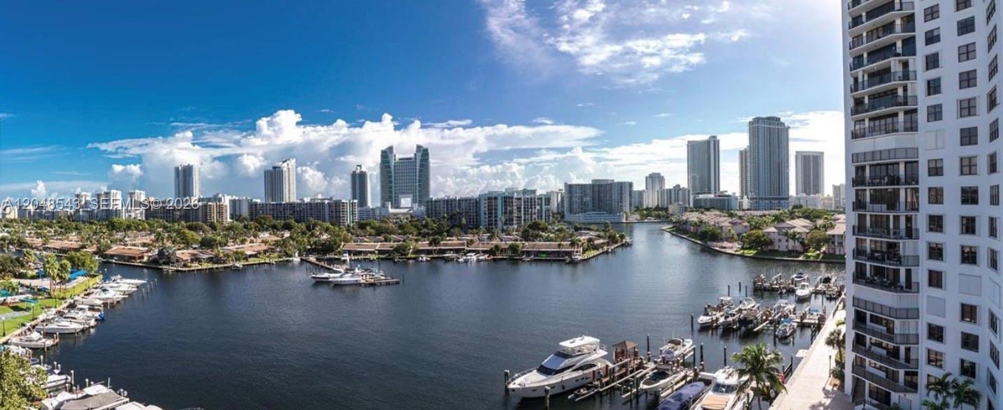 An elevated view of a waterfront marina with boats docked near high-rise apartment buildings — 500 Three Islands Blvd # L25, Hallandale Beach FL 33009, HALLANDALE BEACH, FL