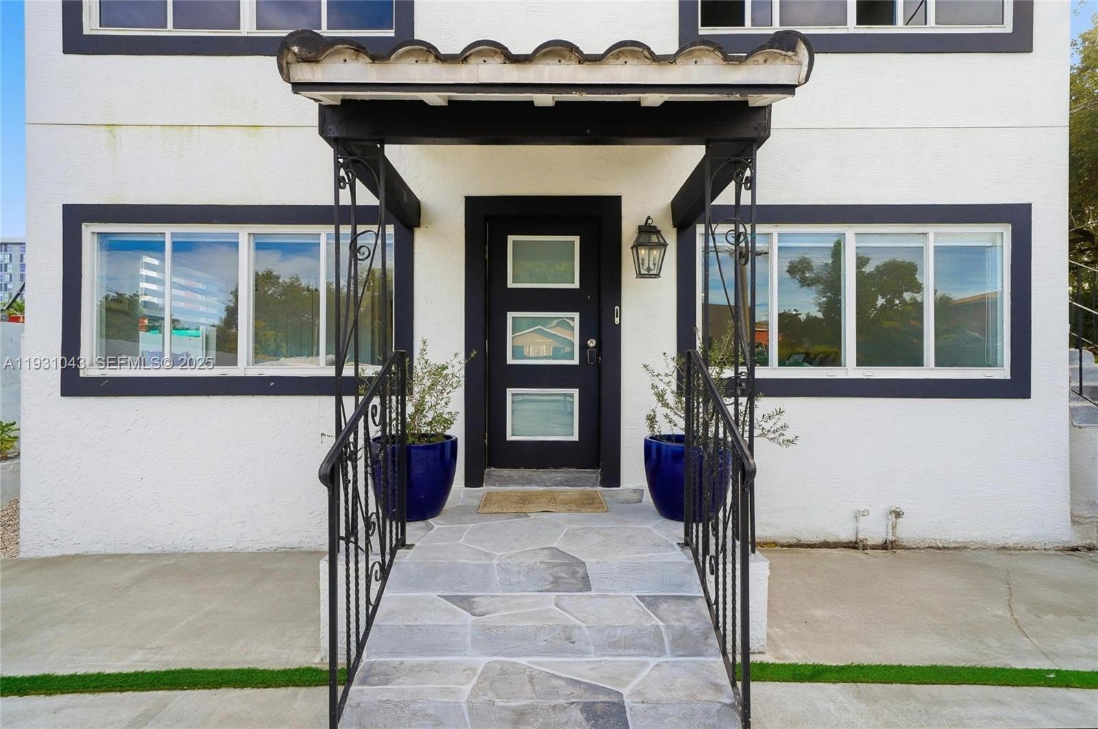 A front entrance features a black door with three glass panels under a tiled awning — 1590 NW 38th St # 1, Miami FL 33142, MIAMI, FL