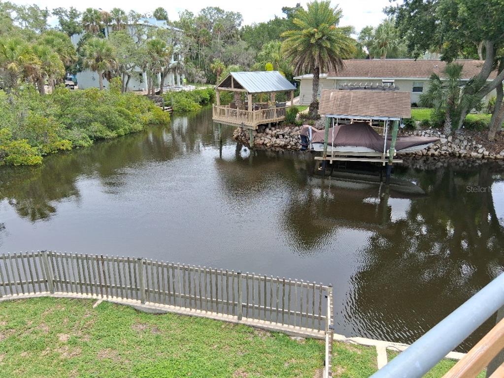 An aerial view of a waterfront house with a pool and surrounding mangrove vegetation — 8720 BETTY STREET, PORT RICHEY, FL