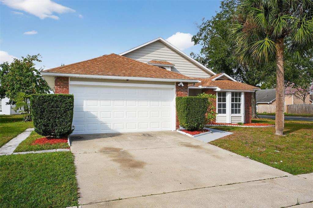 A single-story house with a brick facade, a two-car garage, and a concrete driveway — 233 S ABERDEEN CIRCLE, SANFORD, FL