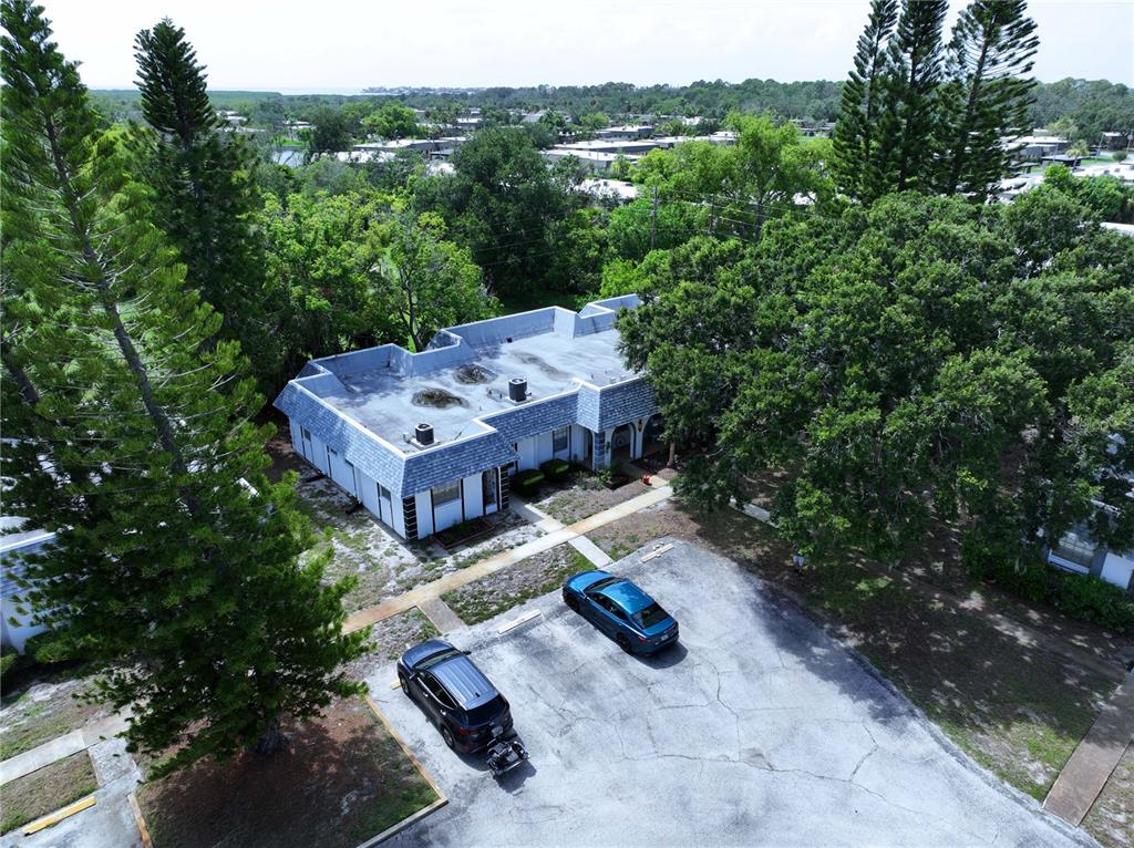 An aerial view shows a single-story building with a flat roof and two parked cars — 4237 REDCLIFF PLACE UNIT -, NEW PORT RICHEY, FL