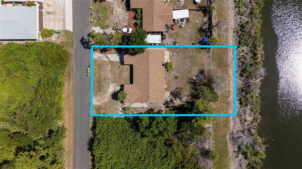 An aerial view shows a single-story house with a brown roof on a large lot — 1825 SHADOW LANE, ENGLEWOOD, FL