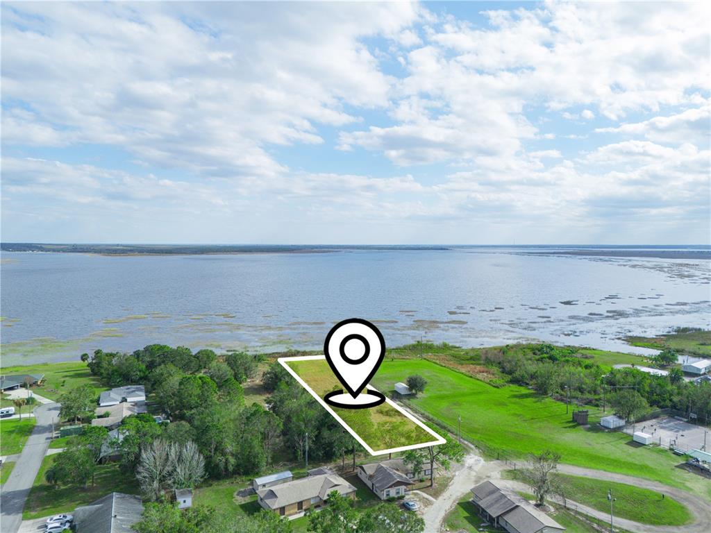An aerial view shows a vacant rectangular lot situated near a large lake — 0 S LAKESHORE LANE, LAKE WALES, FL