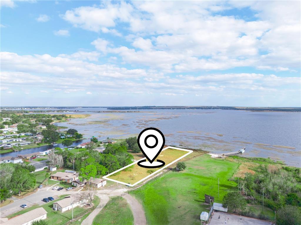 An aerial view shows a vacant waterfront lot marked with a location pin — 0 S LAKESHORE LANE, LAKE WALES, FL