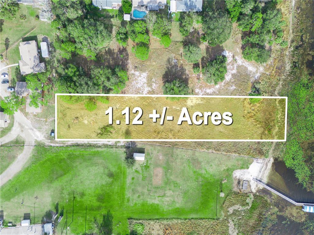 This aerial view shows a rectangular plot of land with trees and a small structure — 0 S LAKESHORE LANE, LAKE WALES, FL
