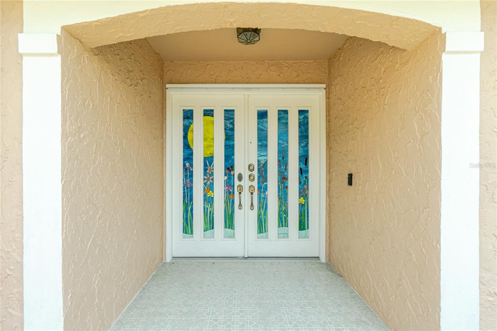 A double front door with stained glass panels is set within a covered entryway — 4088 GINGOLD STREET, PORT CHARLOTTE, FL