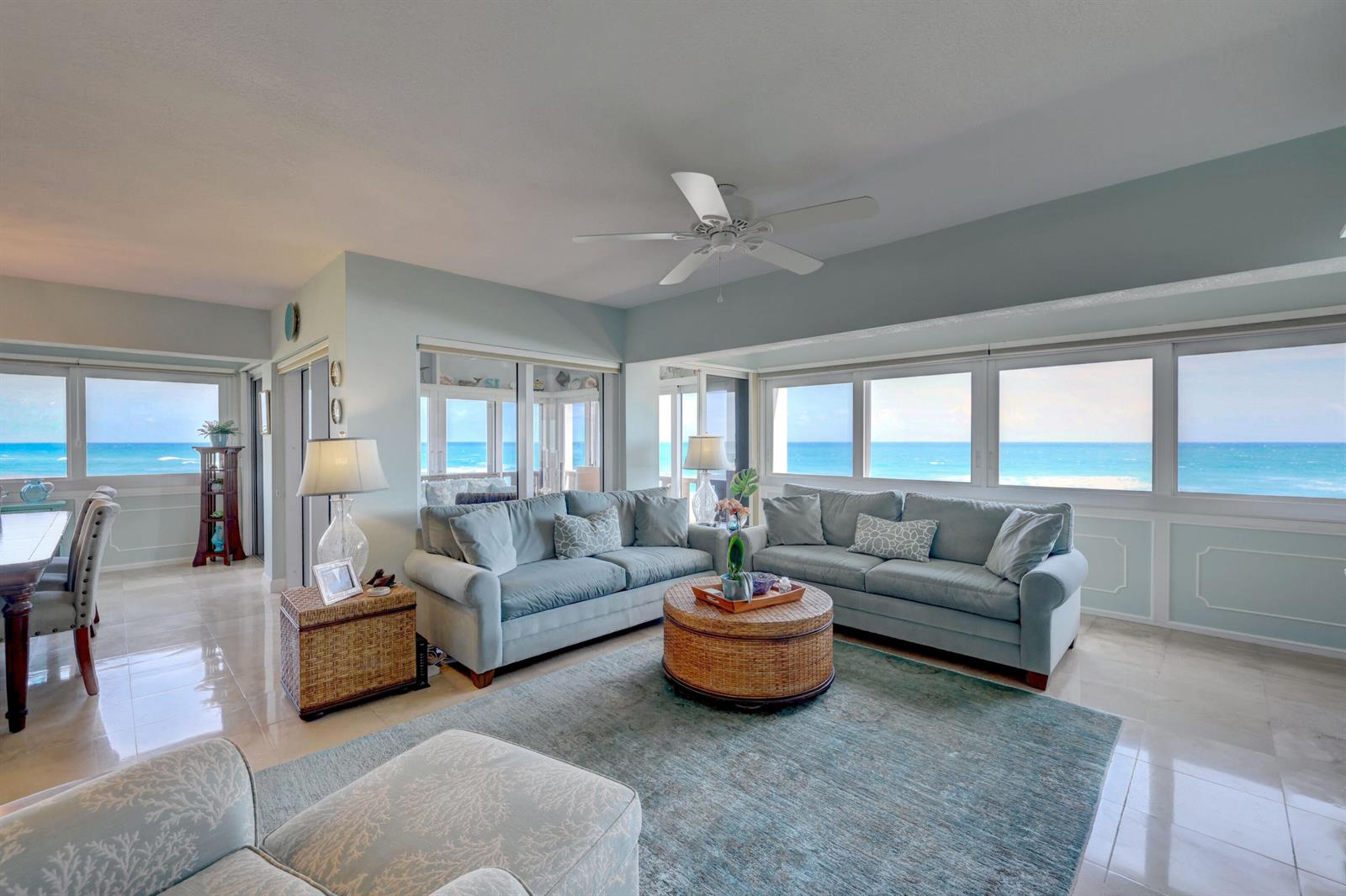 A living room with light blue sofas, a wicker coffee table, and ocean views — 1555 NE Ocean Boulevard # 205, Stuart FL 34996, STUART, FL
