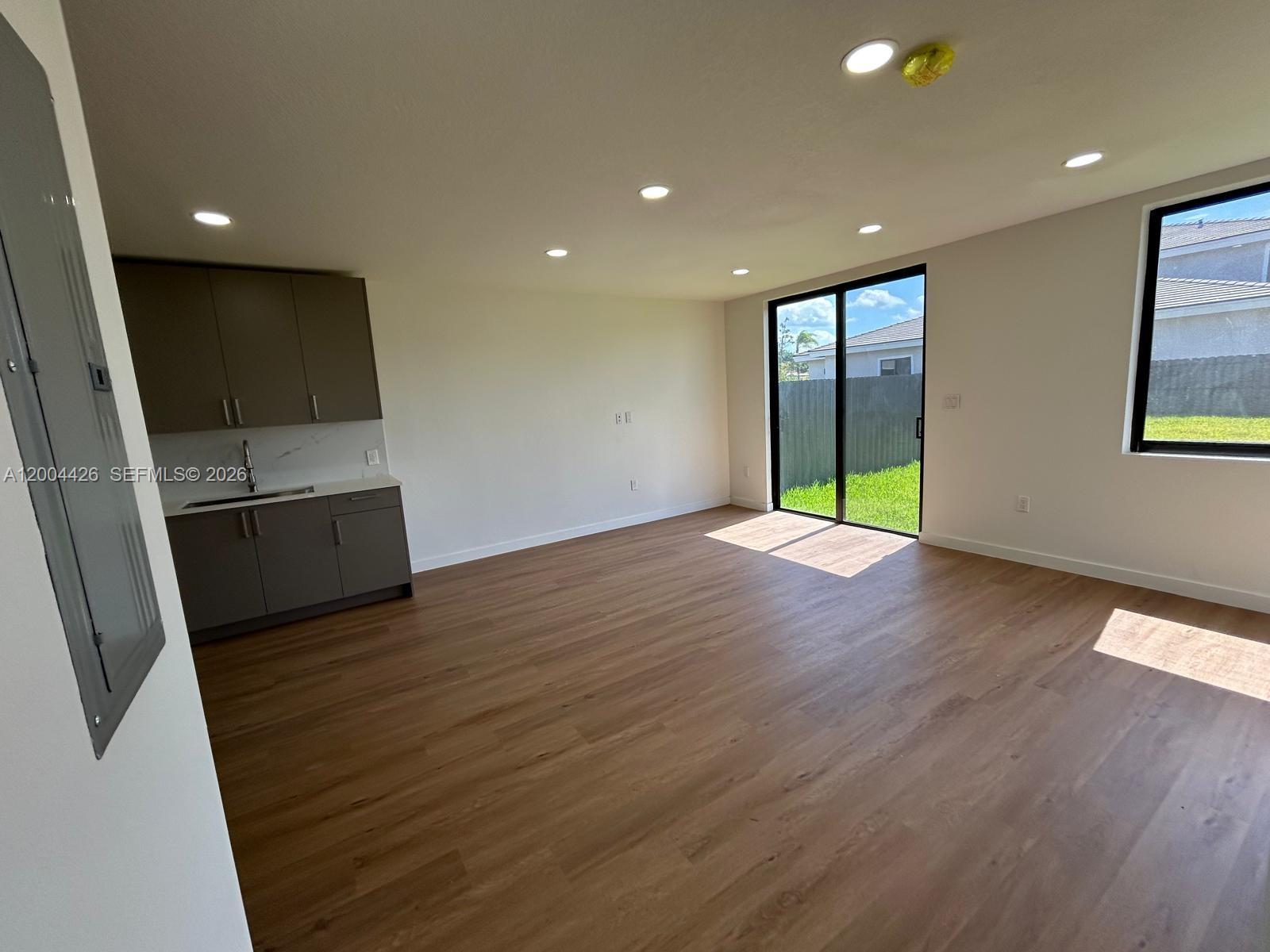The exterior of a home features a dark front door, a white frame, and railings — 12556 SW 194th St # 0, Miami FL 33177, MIAMI, FL