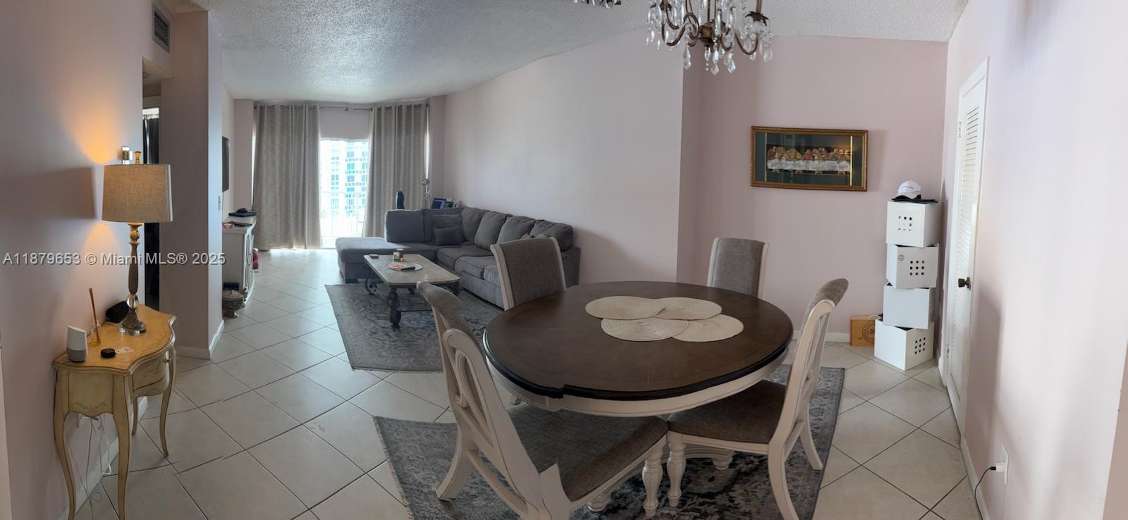 A dining area with a round table and a living room with a sectional sofa — 1965 S Ocean Dr # 7D, Hallandale Beach FL 33009, HALLANDALE BEACH, FL