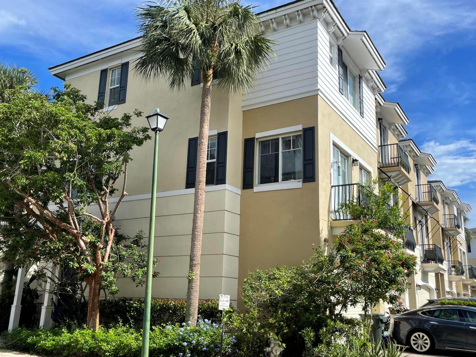 A multi-story tan and white building with balconies and a palm tree in front — 552 NW 39th Circle N, Boca Raton FL 33431, BOCA RATON, FL