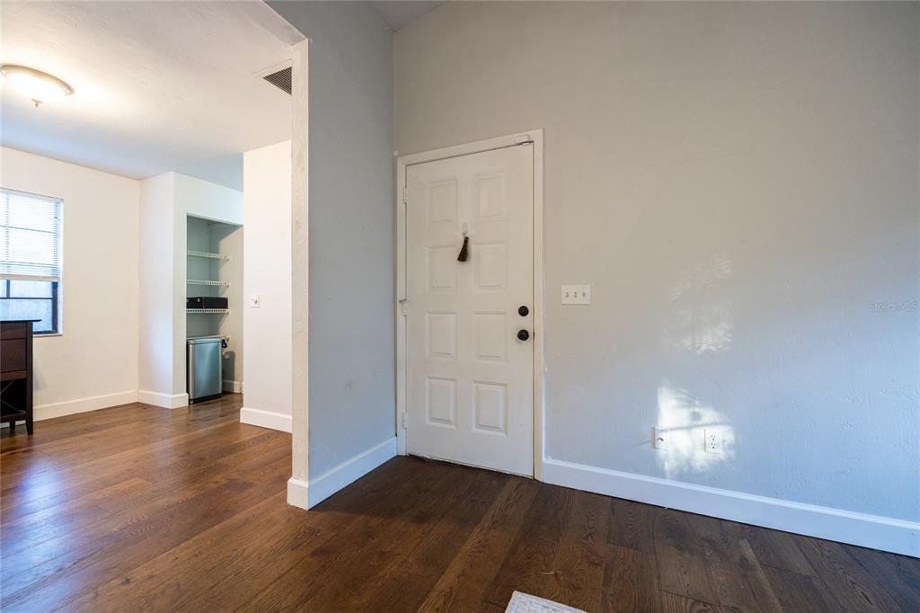A living room features hardwood floors, a white fireplace, a ceiling fan, and two windows — 2116 SW 73RD STREET, GAINESVILLE, FL