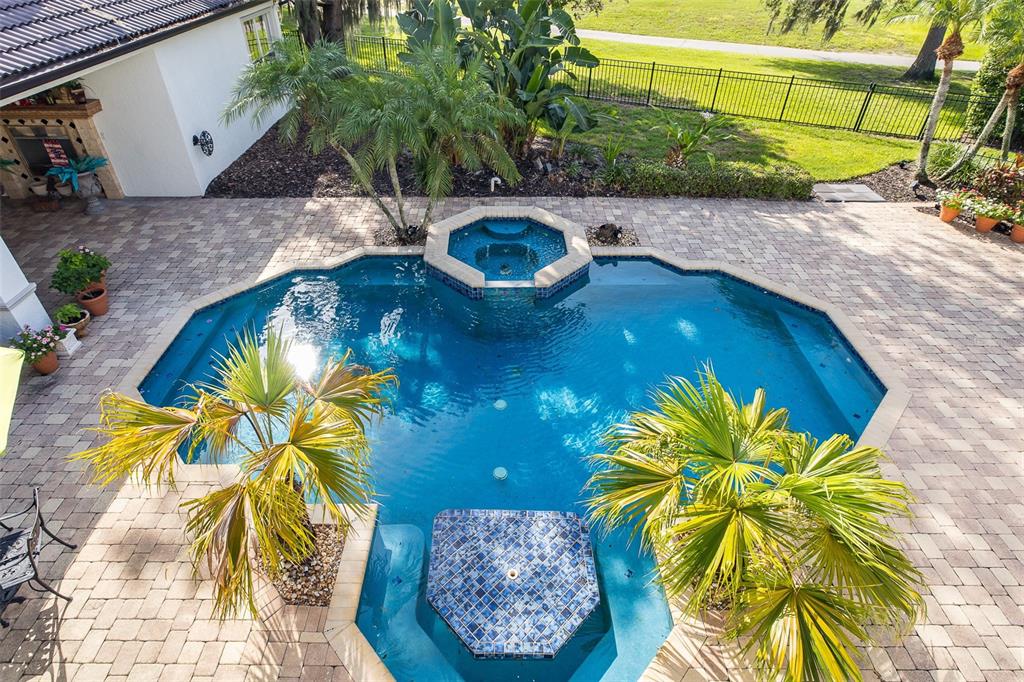 A double front door with glass inserts and wreaths is framed by white pillars — 10628 PONTOFINO CIRCLE, TRINITY, FL