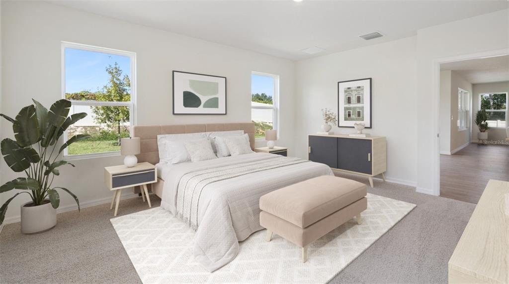 A bedroom features a king bed, a beige bench, two nightstands, and a dark cabinet — 24282 NW 13TH BOULEVARD, NEWBERRY, FL