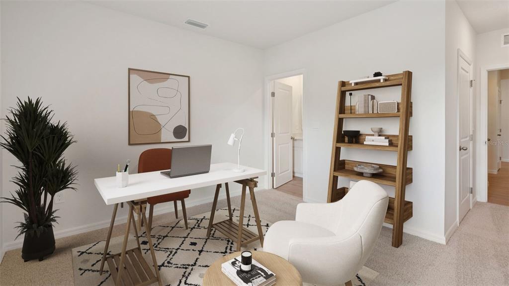 A home office features a white desk, a wooden bookshelf, and a cream-colored accent chair — 24282 NW 13TH BOULEVARD, NEWBERRY, FL
