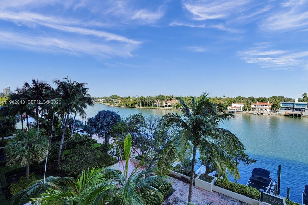 An elevated view of a waterway lined with palm trees and residential properties — 5600 Collins Ave # 5R, Miami Beach FL 33140, MIAMI BEACH, FL