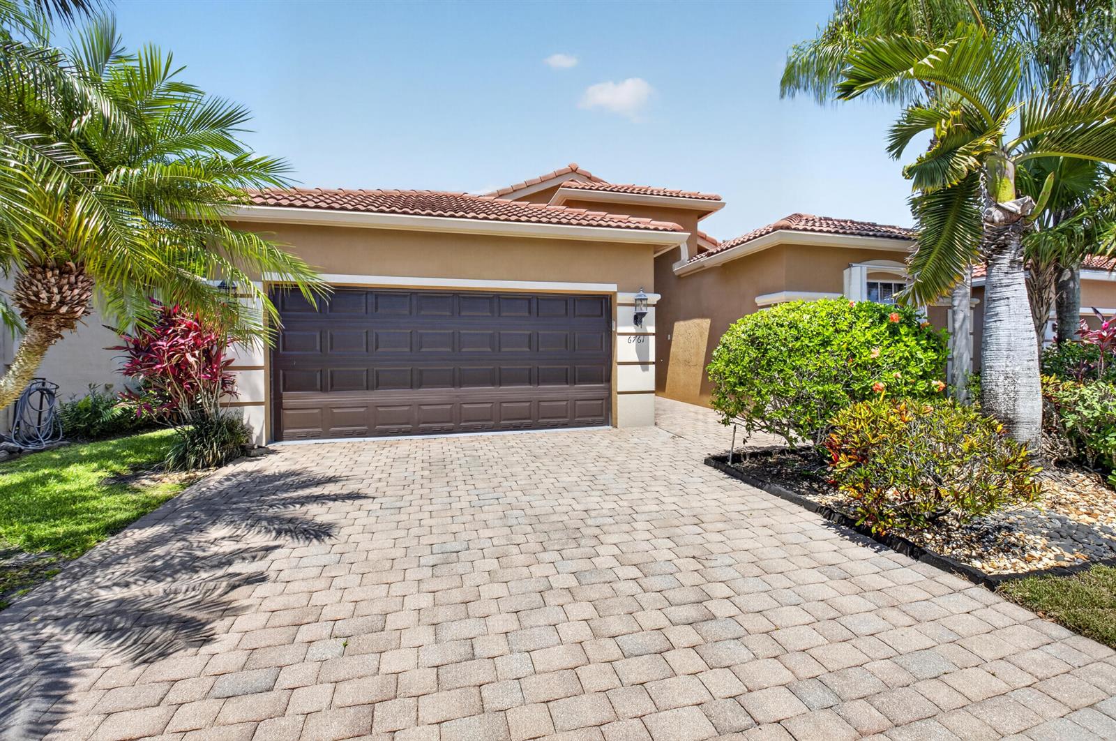A tan stucco house with a brown garage door and a paved driveway — 6761 Pisano Drive, Lake Worth FL 33467, LAKE WORTH, FL