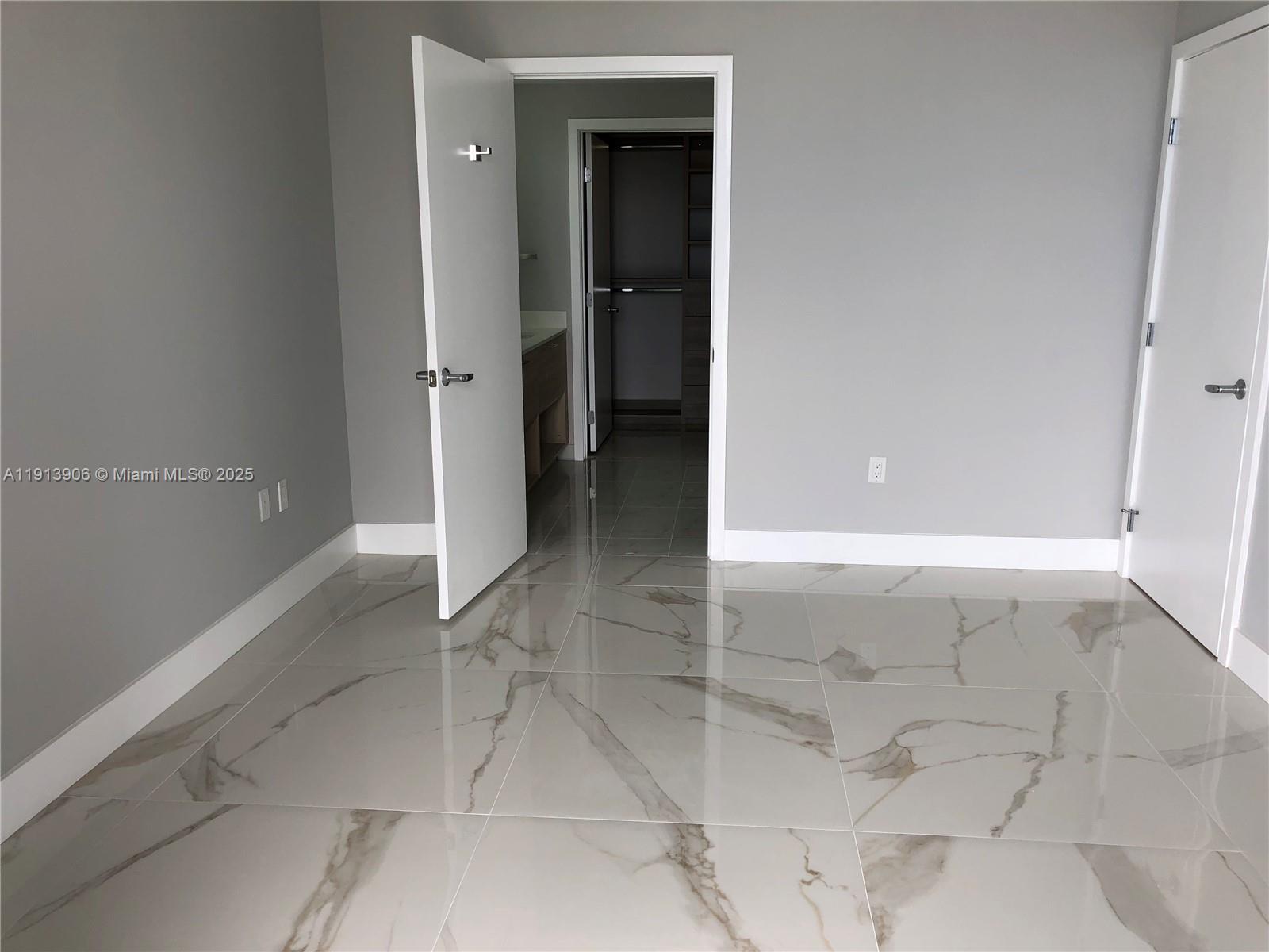 A room with gray walls, white trim, and large, polished marble-look floor tiles — 16385 Biscayne Blvd # 3003, North Miami Beach FL 33160, NORTH MIAMI BEACH, FL
