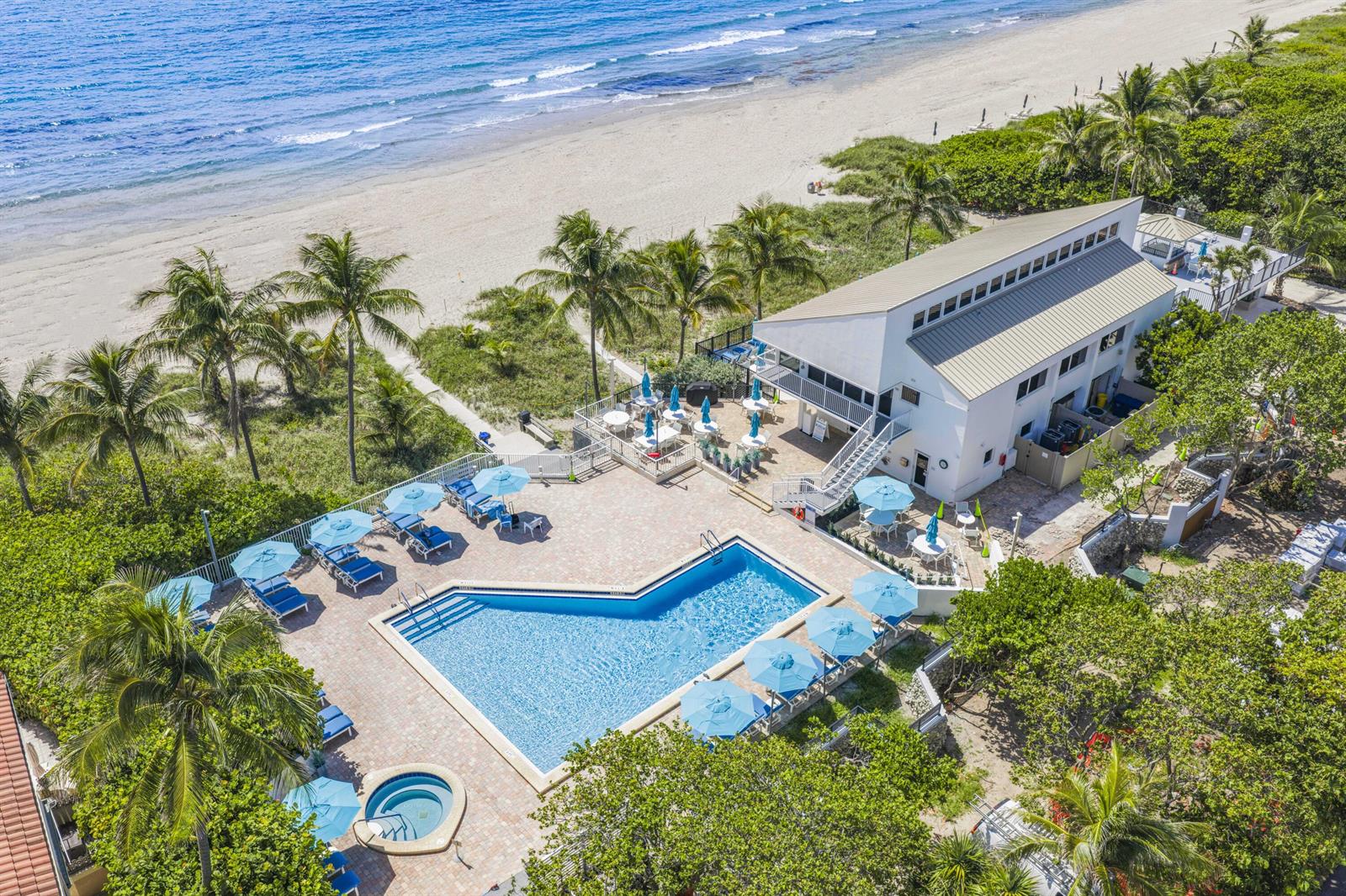 An aerial view shows a beachside building with a swimming pool and a hot tub — 4748 S Ocean Boulevard # 502, Highland Beach FL 33487, HIGHLAND BEACH, FL