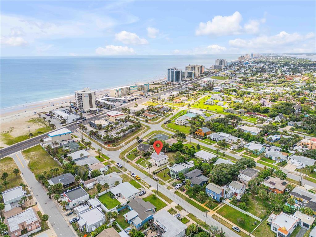 An aerial view shows a residential neighborhood near a beach with a red location marker — 516 WISTERIA ROAD, DAYTONA BEACH, FL